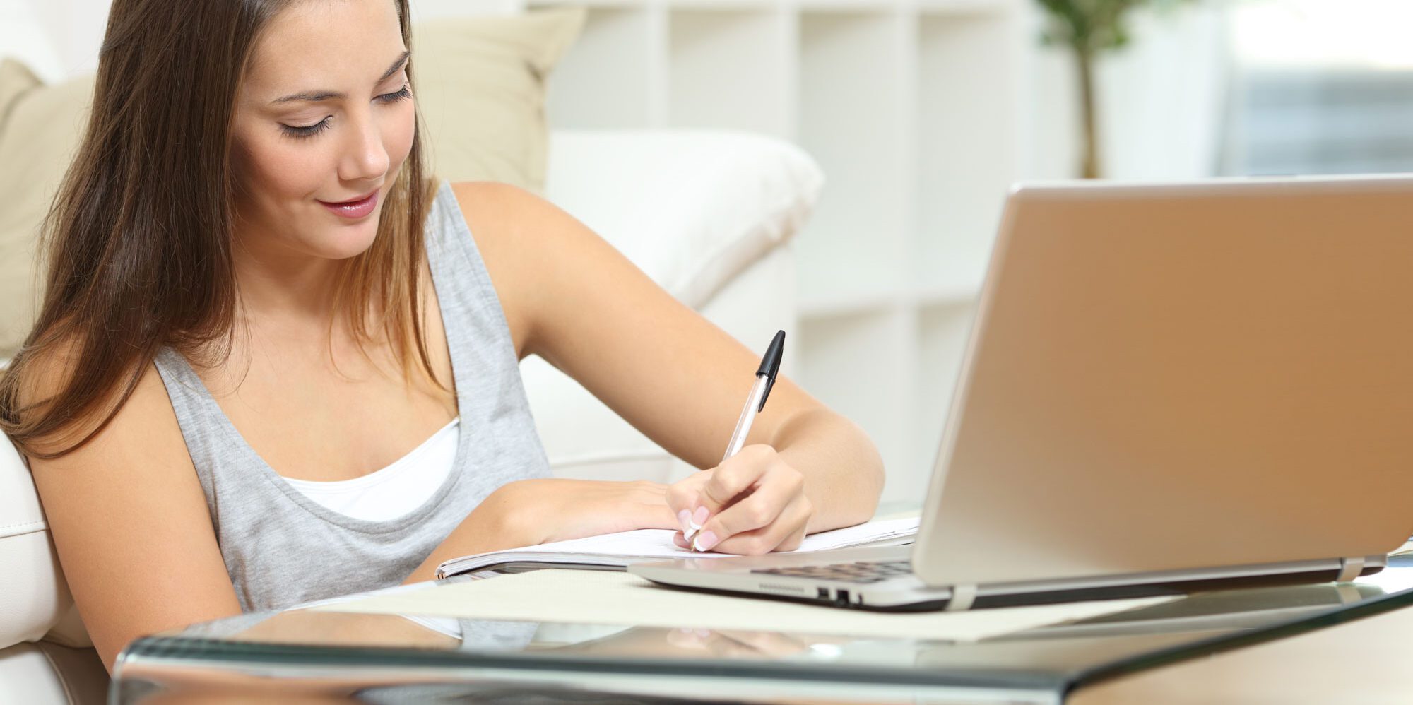teen girl doing homework, writing in a notebook. online high school oregon
